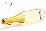 lying champagne bottle with a empty champagne glass on white background