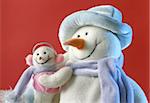 Snowman with his little baby on the red background