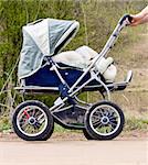 baby stroller in a forest going on the road