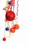 Colorful Christmas baubles hanging on a string on white background with copy space.