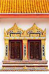 two craved windows with mosaic frame in buddist temple