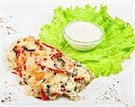 Tasty baked fish with vegetables dish isolated on a white background