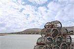 lobster pots on a quay in a bay in ireland