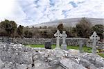 ancient celtic crosses in the graveyard of an old irish church in the countryside