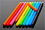 A set of colored felt pens on a black background