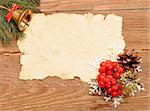 christmas decoration and old paper on brown wood texture