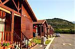 Wooden bungalow row in camping camp park in mountains