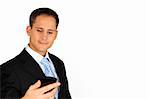 A young and handsome business man reading information on his smartphone while smiling