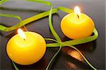 yellow candles showing spa or welllness concept