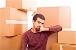 Stressed Young Man on Moving Swamped with Boxes