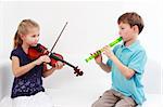 Cute kids playing flute and violin together