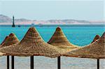 Umbrellas and Red Sea on mount background