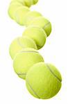 Group of Tennis balls in a row isolated on white background