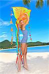 Young woman with kite on the beach