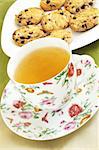 Cup with the green tea and the  cookies