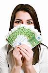 Happy young woman holding money isolate on white