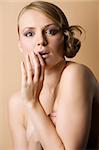 graceful blond woman with naked shoulder and old fashion hair style and a surprised expression
