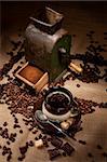 Old coffee mill and cup of coffee with chocolate