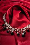 Black pearl necklace on red textile