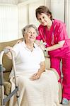 Dignified senior woman in a nursing home, with a caring nurse.