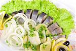 Herring with potato and fresh vegetables closeup