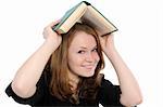 girl with thick and heavy textbook over her head