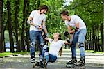 Young people lift the fallen girl on rollers