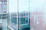 A man in a business suit through the reflection from the window