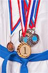 attractive teenage boy wearing winning medal around his neck