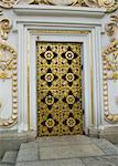 An ancient wooden door with wrought iron ornaments