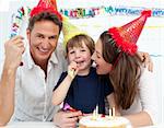 Portrait of a family celebrating little boy's birthday at home