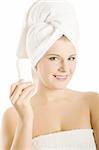 Young beautiful healthy woman with white towel on her head holding anti persperant stick