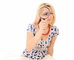 Attractive young blonde holding magnifying glass showing big eye