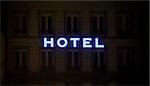 This photograph represent a beautiful illuminated hotel sign taken at night