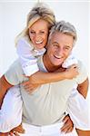 Happy mature couple having fun over white background.