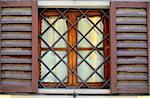 Typical Italian Window With Open Wooden Shutters, Decorated With Grille