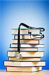 Books and stethoscope against the gradient background