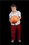 Boy is holding Halloweens orange pumpkin photo on the black background