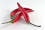 A pile of red hot chili peppers isolated on white background