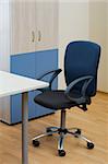 Table, chairs and bookcase at modern office