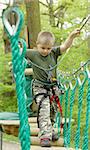 Young boy climbing in the forest colored photo