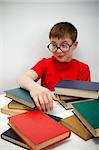 freckled boy in round glasses and a book