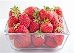 Strawberries in the glass bowl on white background