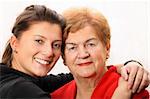 A portrait of a granddaughter posing with her grandma over white background