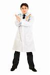 Serious medical doctor with crossed arms isolated on white. Forbidden gesture.