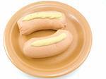 The plate with two appetizing sausages is on a white background