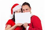 young couple in red christmas clothes holding a white cardboard in hands