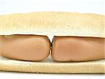 Two sausages are located between two pieces of bread on a white background