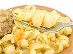 A small amount of boiled macaroni are located on a plug near a plate