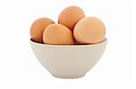 brown eggs in tan bowl on white background